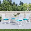 An outdoor patio setting with a white dining set and turquoise cushions. Náhled obrázku produktu