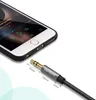 A close-up view of a smartphone and an audio cable with measurement indicators. Produktbild-Vorschau