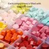 A close-up view of a storage box filled with colorful wax seal beads, organized by color in separate compartments. Náhled obrázku produktu