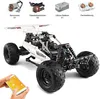 A remote-controlled buggy kit with components laid out and a person holding a smartphone to control it. Náhľad obrázku produktu