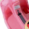Close-up view of the interior of a pink children's electric ride-on toy, showing the footrest area and a warning label. Náhled obrázku produktu