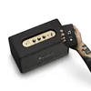 A hand holding a smartphone is shown next to a Marshall speaker. Produktbild-Vorschau