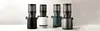 Four slow juicers in different colors are displayed side-by-side on a white surface against a light gray background. Podgląd zdjęcia produktu
