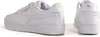 Two views of a pair of white Puma sneakers with gold accents. Produktbild-Vorschau