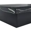 A close-up view of a modern square coffee table with a black base and a marble-look top. Produktbild-Vorschau