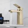 A gold-colored faucet with water running into a sink, with two cosmetic products on the left. Náhľad obrázku produktu