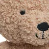 A close-up view of a teddy bear's face. Produktbild-Vorschau