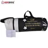 A rolled-up pillow in its branded packaging bag. Produktbild-Vorschau
