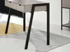 Close-up of the legs and bottom of a desk with drawers, on a rug. Anteprima dell’immagine prodotto
