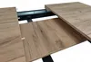 A close-up view of an extendable table with a wooden top and black metal frame. Náhled obrázku produktu