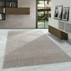 A modern living room with a rug, furniture, and a view of a garden through a large window. Produktbild-Vorschau