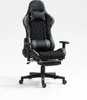 A black and gray gaming chair with a footrest, shown from the front on a white background.