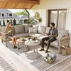 A couple relaxing on a modular outdoor sofa set on a wooden deck, with houses and greenery in the background. Voir les images du produit
