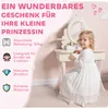 A young girl is sitting at a child's vanity table with a mirror, and text overlays describe the product's features. Produktbild-Vorschau