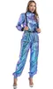 A woman is modeling a metallic jumpsuit with suspenders. Produktbild-Vorschau