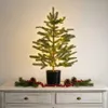A small, decorated artificial Christmas tree with LED lights sits on a white dresser, adorned with a garland of pine sprigs, berries, and pinecones. Produktbild-Vorschau