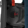 A close-up view of a power tool, likely a router or jigsaw, showing a black plastic housing with red accents and a warning symbol. Náhľad obrázku produktu