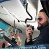 A man in a truck cab holding a radio. Anteprima dell’immagine prodotto
