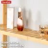 A close-up view of a bamboo shelf with cosmetic products on it. Náhled obrázku produktu