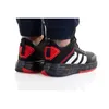 A close-up shot of a person's feet wearing black Adidas basketball shoes with red accents. Podgląd zdjęcia produktu