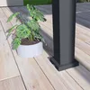 A potted plant sits on a wooden deck next to a dark gray pillar. Náhled obrázku produktu
