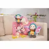 Several stuffed toys, including butterflies and a snail, are arranged on a sofa with a pink pillow. Anteprima dell’immagine prodotto