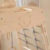 Close-up view of a wooden indoor play structure with a smiley face carved into it. Anteprima dell’immagine prodotto