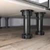 Close-up of adjustable black legs of a kitchen cabinet on a wooden floor. Anteprima dell’immagine prodotto