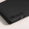 A close-up view of the back of a black electronic device, showing the camera and the brand name. Náhled obrázku produktu