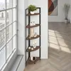 A corner shelf unit with decorative items placed on it, next to a large window. Náhled obrázku produktu