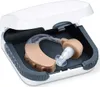 A hearing aid is shown inside its open case. Produktbild-Vorschau