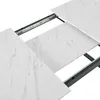 A close-up view of an extendable dining table with a marble-look surface and metal legs. Produktbild-Vorschau