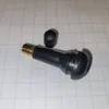 A tire valve stem and its cap are placed on a grid background. Produktbild-Vorschau