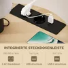 A close-up view of a charging station integrated into a table, with a smartphone in the foreground. Produktbild-Vorschau