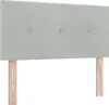 A light gray upholstered headboard with wooden legs, shown against a white background. Produktbild-Vorschau