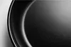 A close-up view of the interior surface of a black frying pan. Produktbild-Vorschau