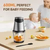 A mother feeding her baby with a spoon, with a food chopper and a bowl of soup on the table. Produktbild-Vorschau