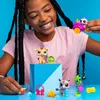 A young girl is playing with Littlest Pet Shop toys, including animal figures and accessories, on a blue surface against a bright blue background. Náhľad obrázku produktu
