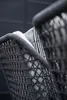 A close-up view of the woven rope detail on a chair, with a striped fabric visible behind it. Produktbild-Vorschau