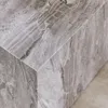 A close-up view of the corner of a square coffee table with a marble-like pattern. Produktbild-Vorschau