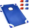 A blue cornhole game board with a hole in the center, and six bean bags (three red and three blue) are shown next to it. Podgląd zdjęcia produktu