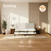 A bedroom scene featuring an Emma Original 18 Hybrid mattress on a bed frame, with bedside tables and decorative elements. Produktbild-Vorschau