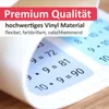 A close-up of a rolled-up vinyl placemat with multiplication problems printed on it, set against a wooden surface. Náhled obrázku produktu