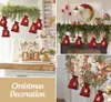A collage of Christmas decorations including fabric bags hanging from greenery, a gingerbread house, and a decorated wreath. Anteprima dell’immagine prodotto