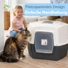 A cat and a child are near a large litter box in a living room setting. Produktbild-Vorschau