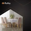 A dining table set with chairs, covered by a white tablecloth, with a plant and candles as decoration. Náhľad obrázku produktu