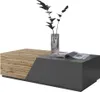A modern coffee table with a wood and gray finish, featuring a vase with dark branches and an open magazine on top. Náhled obrázku produktu