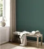 A cozy interior scene with a bench, books, and a lamp. Produktbild-Vorschau