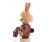 A wooden Easter bunny figurine holding a basket of eggs, shown in profile against a white background. Produktbild-Vorschau