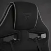 A close-up view of the headrest and upper back of a black and gray gaming chair. Anteprima dell’immagine prodotto